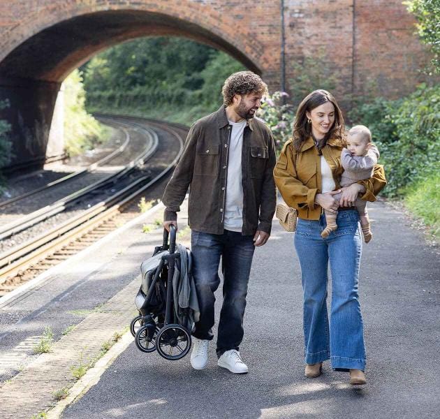 Parent carrying lightweight stroller