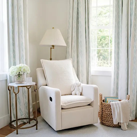 Bebe & Beyond Nestler Recliner Nursing Chair in Off White Boucle styled in a bright nursery corner with side table and lamp