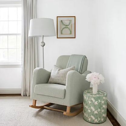 Bebe & Beyond Soother Nursing Chair in Sage Boucle styled in a bright neutral nursery with floor lamp and decorative side table