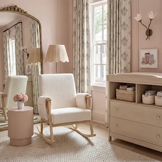 Bebe & Beyond Storyteller Nursing Chair styled in a soft pink nursery alongside natural wood furniture