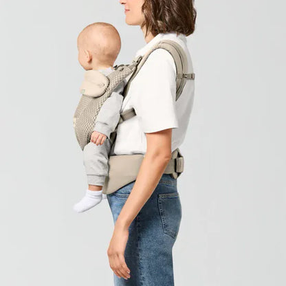 Parent carrying baby facing outward in the Cybex Amya Baby Carrier, side view