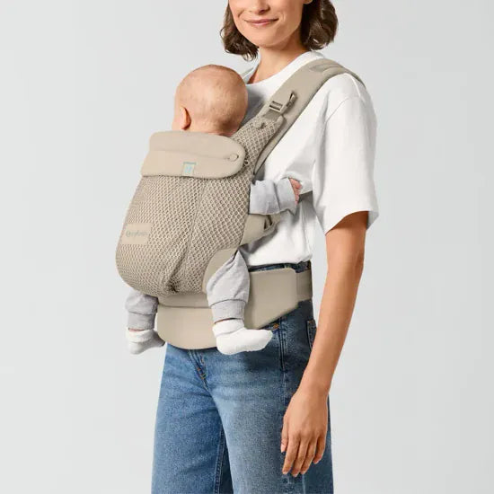 Parent carrying baby facing inward in the Cybex Amya Baby Carrier, side view showing ergonomic seat position