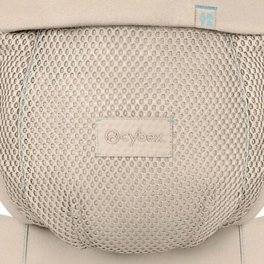 Close-up of the Cybex Amya Baby Carrier mesh panel in Natural Beige, showing breathable honeycomb fabric and embossed Cybex logo